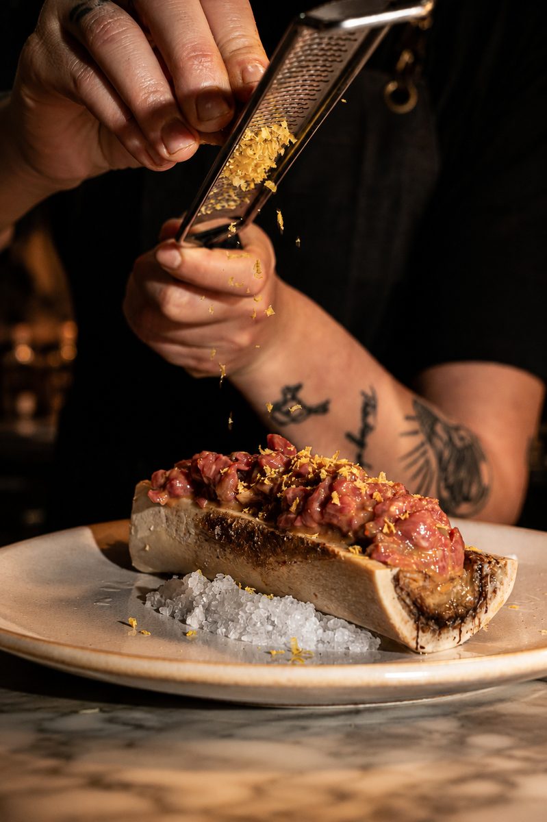 Our chef prepares a dish for the table